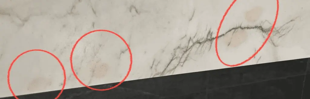 Quartzite benchtop showing dark stains where liquid has soaked into porous areas